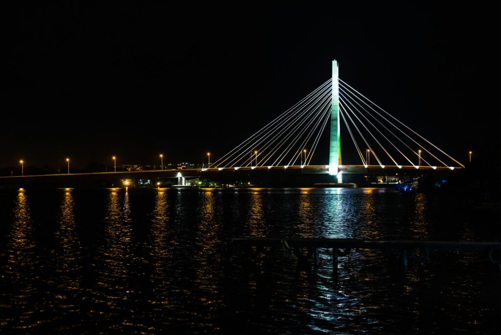 a large bridge over a body of water at night